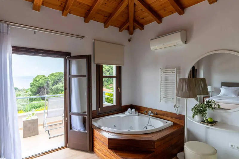Classic Style Villa: a bedroom with a whirlpool bath and balcony doors