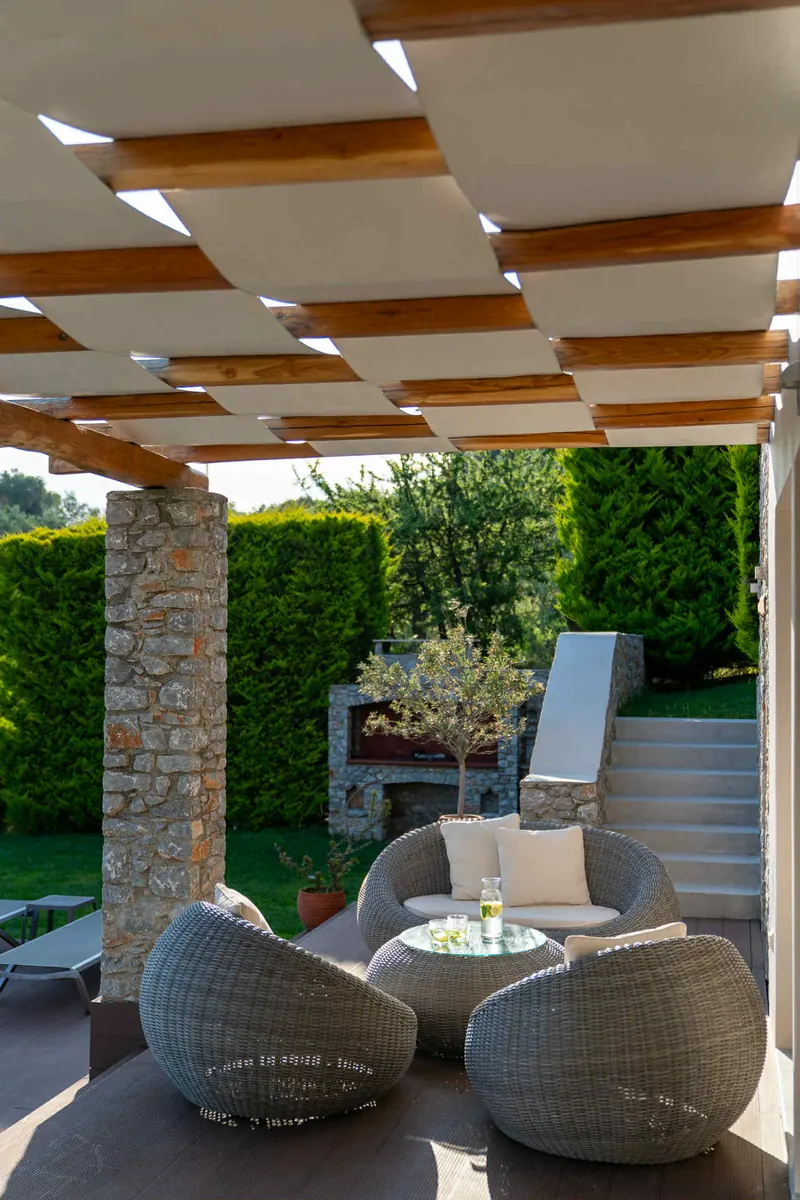 Classic Style Villa: lounge chairs under the pergola
