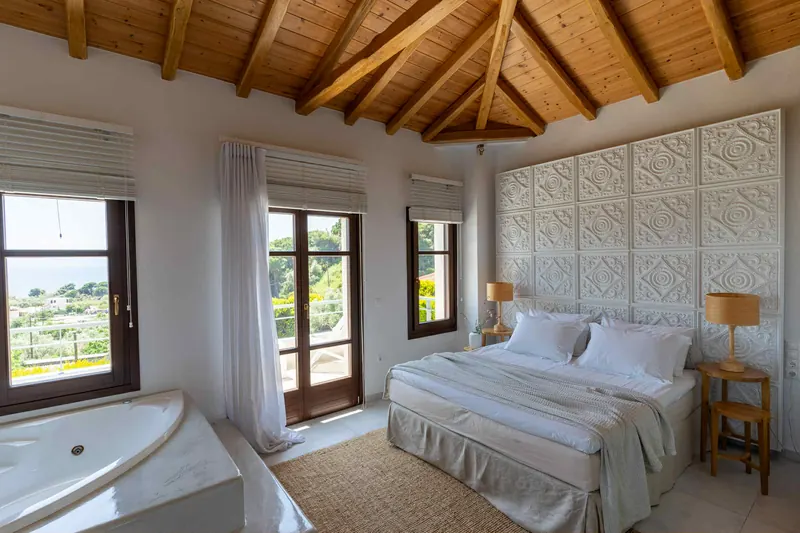 Modern Style Villa: a bedroom under the timber roof